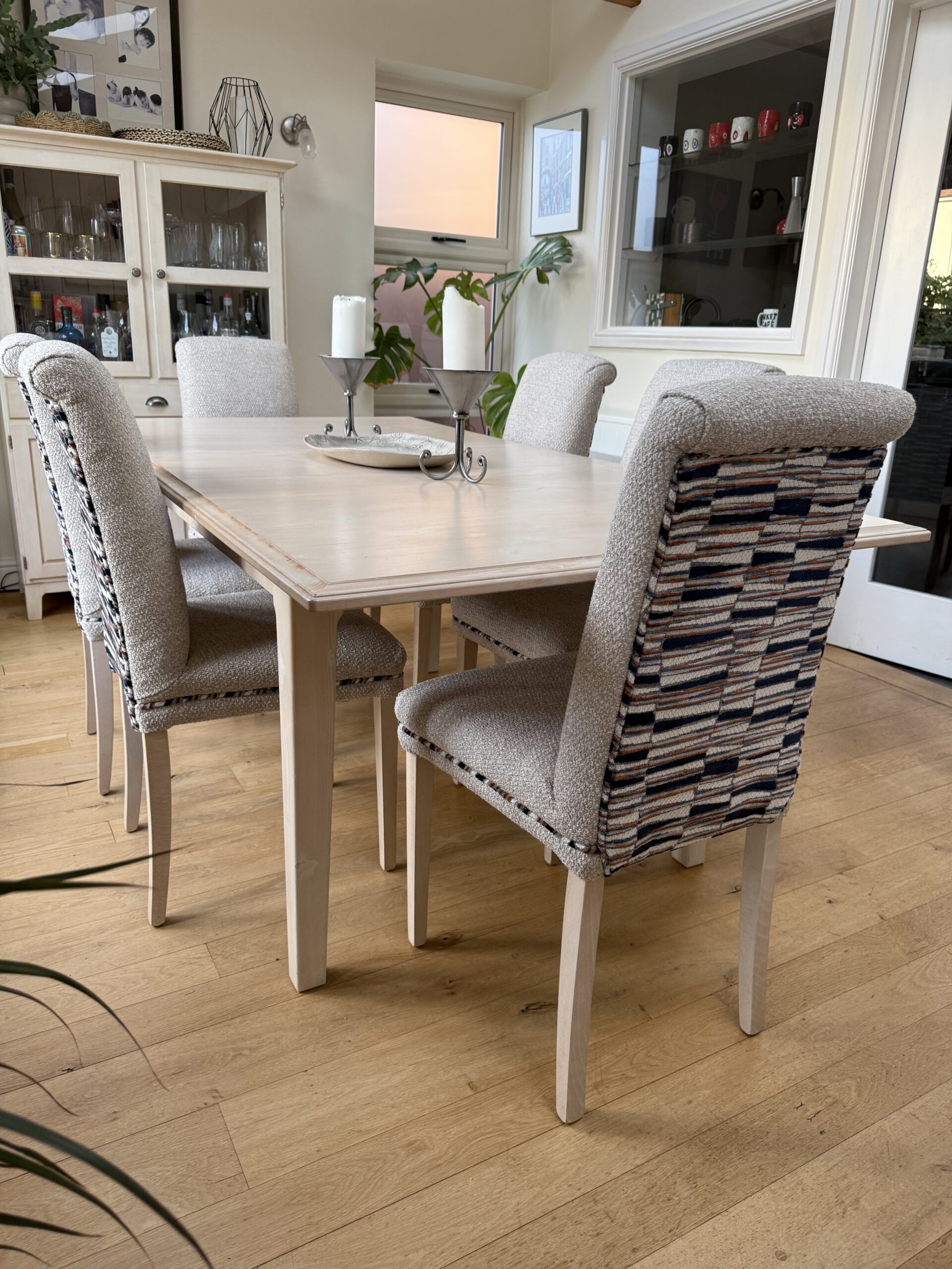 Dining chairs reupholstered with neutral seats and patterned backs by Creature Comforts Upholstery