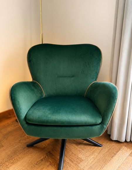 Green velvet chair reupholstered with contrast piping by Creature Comforts Upholstery