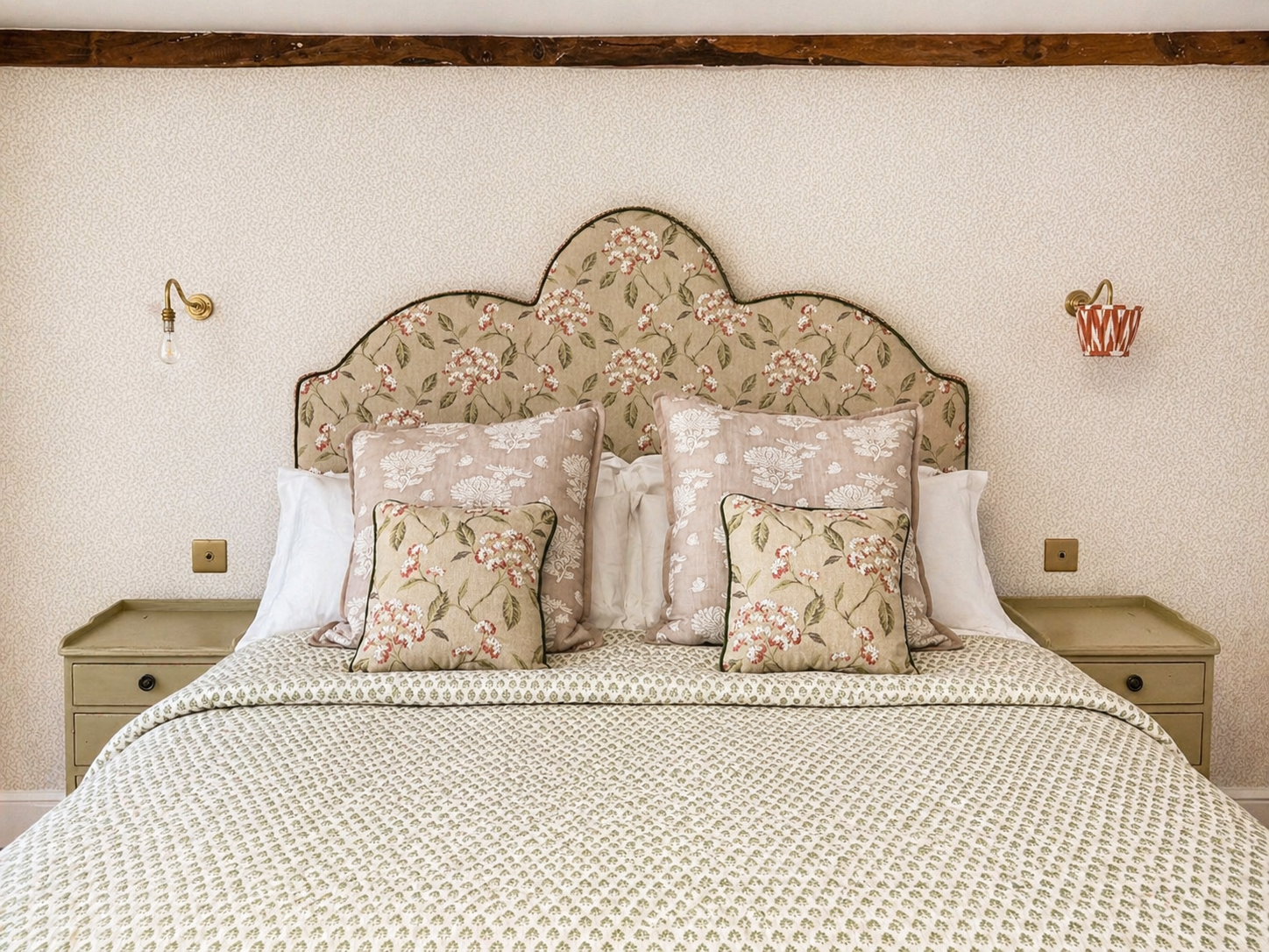 Bespoke floral upholstered headboard with matching cushions and contrast piping
